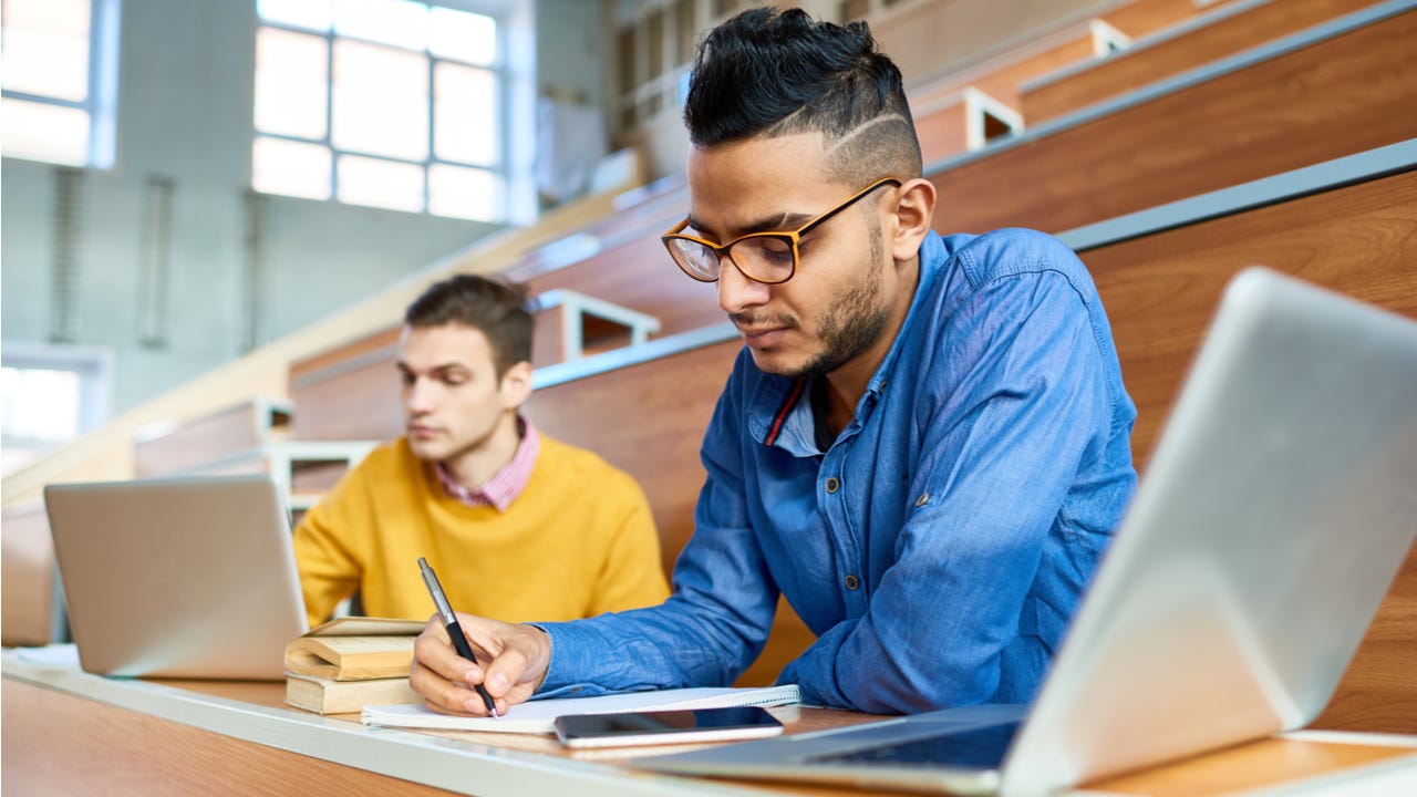 Students study in a college lecture hall