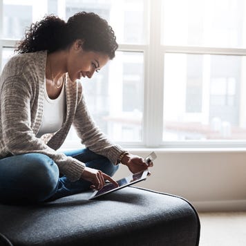 Person looking at tablet and credit card